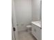 Powder room showcases a white vanity, modern fixtures, neutral walls, and tile flooring at 36233 Joseph Blake St, Zephyrhills, FL 33541