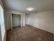 Well-lit bedroom featuring neutral carpet and a closet with bi-fold doors at 36233 Joseph Blake St, Zephyrhills, FL 33541