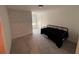 Cozy bedroom with neutral carpet, textured accent wall, and ample natural light at 36233 Joseph Blake St, Zephyrhills, FL 33541