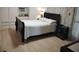 Cozy bedroom with sleek black bed frame, matching nightstand, and ample built-in closet space at 4300 E Bay Dr # 309, Clearwater, FL 33764