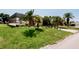 An enclosed lanai is surrounded by a lush lawn, offering privacy at 4434 Dewey Dr, New Port Richey, FL 34652