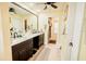 Bathroom featuring double sinks, dark cabinets, and tile flooring at 4434 Dewey Dr, New Port Richey, FL 34652