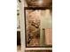 Bathroom features a tiled shower with glass doors and bronze fixtures at 4434 Dewey Dr, New Port Richey, FL 34652