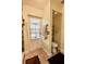 Bathroom features a door leading to the exterior and a neutral-colored toilet at 4434 Dewey Dr, New Port Richey, FL 34652