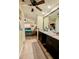 Primary bathroom featuring dual sink vanity and entrance to main bedroom at 4434 Dewey Dr, New Port Richey, FL 34652