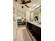 Primary bathroom featuring dual sink vanity and entrance to main bedroom at 4434 Dewey Dr, New Port Richey, FL 34652
