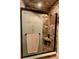 Tiled shower features mosaic glass, a built-in bench, and bronze fixtures at 4434 Dewey Dr, New Port Richey, FL 34652