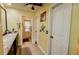 Bright bathroom features a large vanity with marble countertop and updated tile floors at 4434 Dewey Dr, New Port Richey, FL 34652