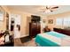 Comfortable bedroom with shuttered windows, ceiling fan, and cozy furniture at 4434 Dewey Dr, New Port Richey, FL 34652