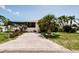 The spacious driveway leads to a screened lanai and a lush backyard at 4434 Dewey Dr, New Port Richey, FL 34652