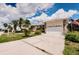 Well-kept single-story home with tidy lawn, spacious driveway, and an attached two-car garage at 4434 Dewey Dr, New Port Richey, FL 34652