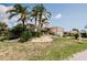 Inviting single-story home with lush lawn, palm trees, and stone accents at 4434 Dewey Dr, New Port Richey, FL 34652