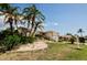 Inviting single-story home with lush lawn, palm trees, and stone accents at 4434 Dewey Dr, New Port Richey, FL 34652