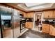 Traditional eat-in kitchen features stainless steel appliances and wood cabinetry, offering ample space for cooking and storage at 4434 Dewey Dr, New Port Richey, FL 34652