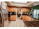 Well-appointed kitchen with stainless steel appliances, wood cabinets, and tile flooring offers ample cooking and storage space at 4434 Dewey Dr, New Port Richey, FL 34652