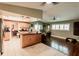 An open kitchen/living area boasts tile and wood flooring, stainless appliances, and modern lighting at 4434 Dewey Dr, New Port Richey, FL 34652