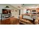 Comfortable living space featuring hardwood floors, fireplace, and open flow to the kitchen at 4434 Dewey Dr, New Port Richey, FL 34652