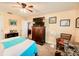 Main bedroom showing carpeted floors, fan, and a flat screen tv at 4434 Dewey Dr, New Port Richey, FL 34652