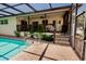 Inviting pool and covered patio, accessible via brick steps and complete with screen enclosure at 4434 Dewey Dr, New Port Richey, FL 34652