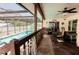 Relaxing screened-in pool area, featuring a spacious patio, ceiling fan, and clear blue water at 4434 Dewey Dr, New Port Richey, FL 34652