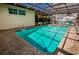 Inviting enclosed pool featuring ample sunlight, refreshing clear water, and a leafy green yard at 4434 Dewey Dr, New Port Richey, FL 34652