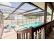 Screened pool is surrounded by lounge chairs and patio, perfect for outdoor relaxation at 4434 Dewey Dr, New Port Richey, FL 34652