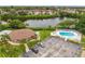 Aerial view of the property showcasing surrounding landscaping, parking, pool, clubhouse, and lake views at 4510 Overlook Ne Dr # 224, St Petersburg, FL 33703