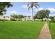 Landscaped lawns surround the condominium complex with mature trees and manicured walkways at 4510 Overlook Ne Dr # 224, St Petersburg, FL 33703