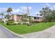 View of Lake Overlook Condominiums signage with lush landscaping and an American flag on display at 4510 Overlook Ne Dr # 224, St Petersburg, FL 33703