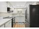 Modern kitchen featuring stainless steel appliances, white cabinetry, and sleek countertops at 4510 Overlook Ne Dr # 224, St Petersburg, FL 33703