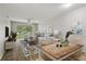 Inviting living room with neutral tones, open dining area, and sliding glass doors to the outside at 4510 Overlook Ne Dr # 224, St Petersburg, FL 33703