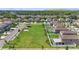 Aerial view of houses with fenced backyards surrounding a large green lawn at 4726 Wild Senna Blvd, Tampa, FL 33619