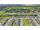Aerial view of a residential neighborhood with houses, green spaces, and a small lake at 4726 Wild Senna Blvd, Tampa, FL 33619