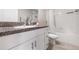 Clean bathroom with a granite countertop, white cabinets, and a shower-tub combination at 4726 Wild Senna Blvd, Tampa, FL 33619