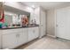 Bathroom with double sinks, granite countertops, and white cabinets at 4726 Wild Senna Blvd, Tampa, FL 33619