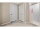 Clean bathroom with tile flooring, white doors, and a walk-in shower at 4726 Wild Senna Blvd, Tampa, FL 33619