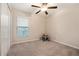 Comfortable carpeted bedroom featuring a ceiling fan, closet space, and a window for natural light at 4726 Wild Senna Blvd, Tampa, FL 33619