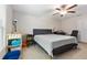 Cozy bedroom with a ceiling fan, carpeted floors, and a neutral color palette at 4726 Wild Senna Blvd, Tampa, FL 33619