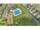 An aerial view of a community pool and playground surrounded by homes at 4726 Wild Senna Blvd, Tampa, FL 33619