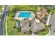 Aerial shot of the community pool, playground and clubhouse with surrounding landscape at 4726 Wild Senna Blvd, Tampa, FL 33619