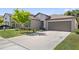 Beautiful single-Gathering home with a two-car garage and a well-manicured lawn showcasing lovely landscaping at 4726 Wild Senna Blvd, Tampa, FL 33619
