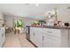 Bright kitchen featuring a large island, white cabinetry, and stainless steel dishwasher at 4726 Wild Senna Blvd, Tampa, FL 33619