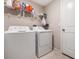 Functional laundry room with a washer, dryer, and storage shelves at 4726 Wild Senna Blvd, Tampa, FL 33619