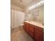 Well-lit bathroom features a spacious vanity, elegant mirror, and a shower with a curtain at 4745 Trout River Xing, Ellenton, FL 34222