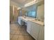 Bright bathroom featuring double sinks, a walk-in shower, and a large mirror at 4745 Trout River Xing, Ellenton, FL 34222