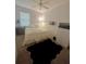 Cozy bedroom with a plush rug, ceiling fan, and natural light, perfect for relaxation at 4745 Trout River Xing, Ellenton, FL 34222