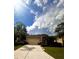 Charming single-story home with a paved driveway, lush landscaping, and a two-car garage at 4745 Trout River Xing, Ellenton, FL 34222