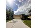 A charming single-story home with a paved driveway, lush landscaping, and a two-car garage at 4745 Trout River Xing, Ellenton, FL 34222