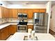 Well-appointed kitchen featuring stainless steel appliances, stylish cabinetry, and modern lighting fixtures at 4745 Trout River Xing, Ellenton, FL 34222