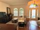 Cozy living room with wood floors, arched windows and doorways, and neutral-toned furniture at 4745 Trout River Xing, Ellenton, FL 34222